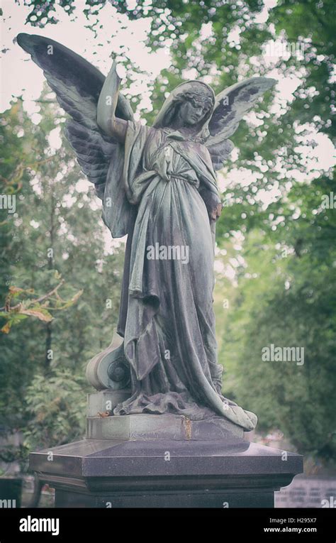 Old, beautiful sculpture of an angel in the cemetery Stock Photo - Alamy