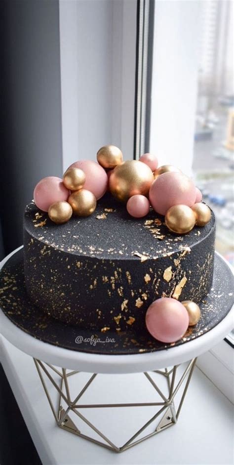 39 Cake design Ideas 2021 : Black Cake Topped with Pink & Gold Balls