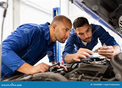 Mechanic Men with Wrench Repairing Car at Workshop Stock Photo - Image ...