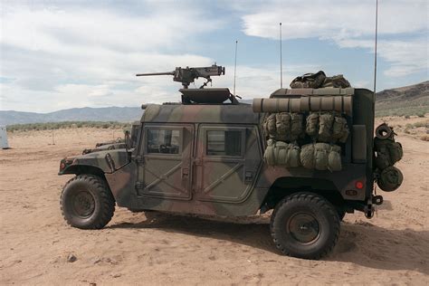 A left side view of a US Army M998 High-Mobility Multipurpose Wheeled Vehicle equipped with an ...