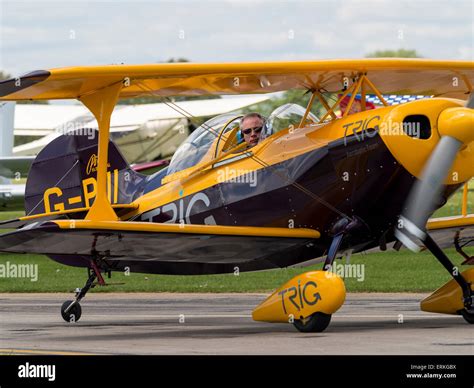 the pilot of a Pitts Special aerobatic biplane looks out of the cockpit ...