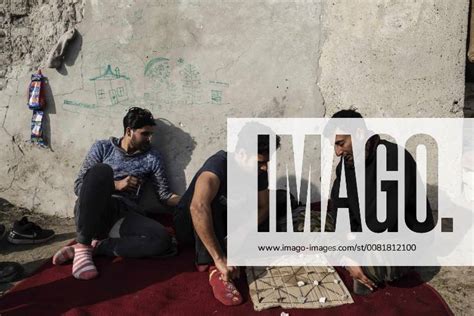 January 27, 2018 Horgos, Kanjiza, Serbia Migrants from Pakistan pass the time by playing a board ...