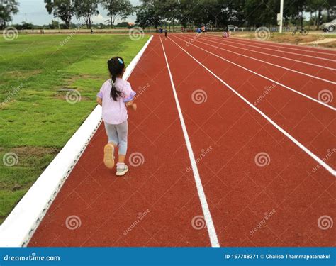 Asian Child Girl Running on Red Track. Stock Image - Image of blurred ...