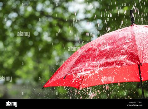 Red umbrella outdoors on rainy day Stock Photo - Alamy