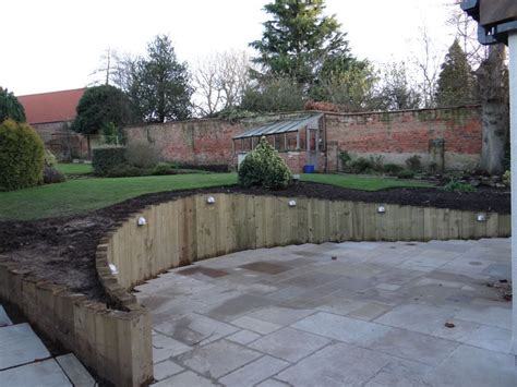 Wall from new railway sleepers | Sleepers in garden, Landscaping retaining walls, Back garden design