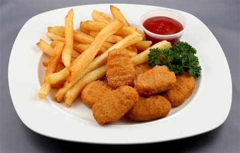 fried fish and fries with ketchup on a white plate