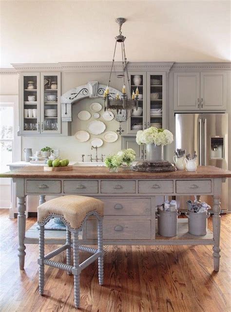 a large kitchen island with two stools in front of it and plates on the wall