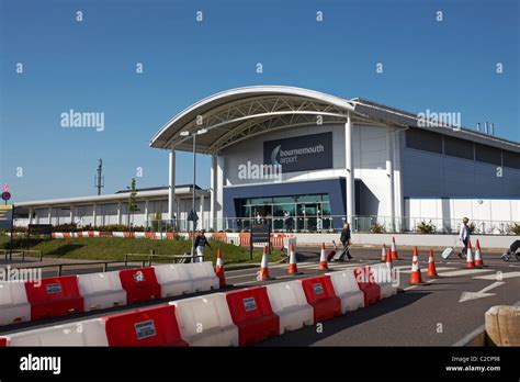 People heading into Bournemouth Airport departures terminal entrance to get away for their ...