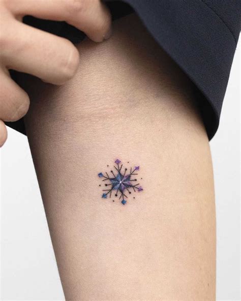 Tiny snowflake tattoo by Rey Jasper tattooed on the left forearm | Snow ...