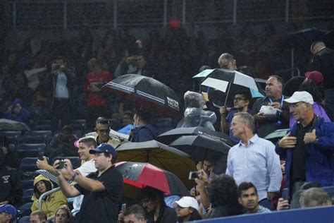 Fans React to Rain Disruption in the Louis Armstrong Stadium at US Open ...