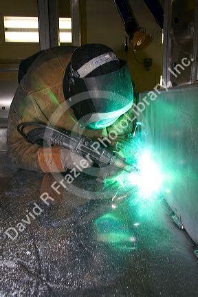 Worker Heliarc welding an aluminum truck chassis at Spartan Motors manufacturing plant in ...