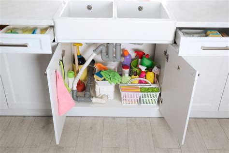 Open Under Sink Cabinet with Different Cleaning Supplies in Kitchen Stock Photo - Image of ...