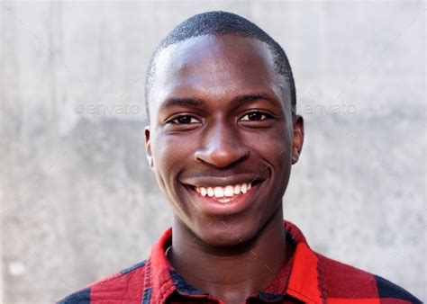 Smiling face of young african man Stock Photo by mimagephotography