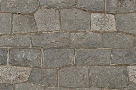 Premium Photo | A wall of grey stones with the word stone on it