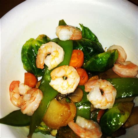 a white bowl filled with shrimp and veggies