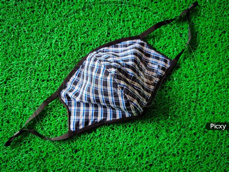 Image of One Blue Color Checked Cloth Face Mask Isolated On Green ...