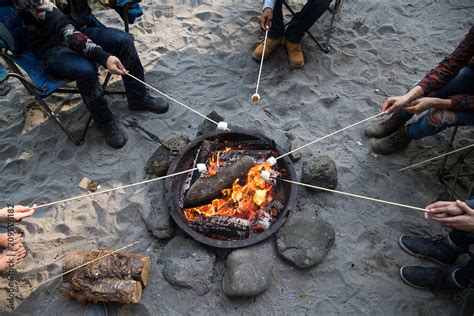 Roasting marshmallow at campfire Stock Photo | Adobe Stock