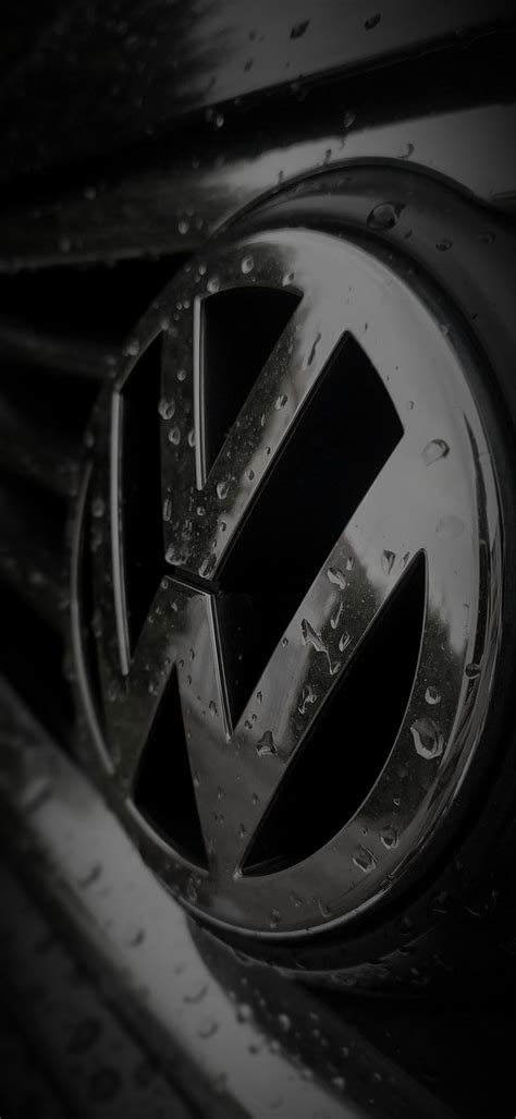 the volkswagen logo is shown in this black and white photo with water ...