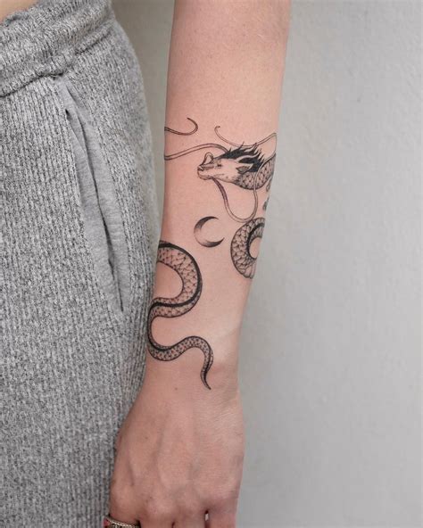 a delicate dragon that wraps around the arm. swipe to see it in action ...