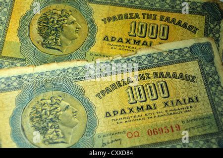 Greek old currency drachma banknotes piled on the Greek flag Stock ...