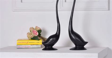 Two Black Geese Figurines on White Console Table · Free Stock Photo