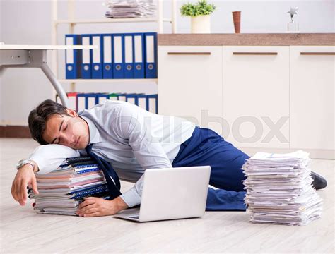 Extremely busy employee working in the office | Stock image | Colourbox