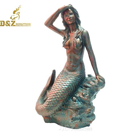 mermaid sitting on a rock statue