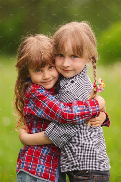 Two girls hugging each other on featuring two, beautiful, and children | People Images ...