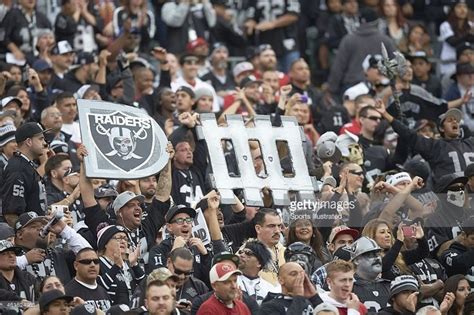 Oakland Raiders fans with signs in stands during game vs San ...