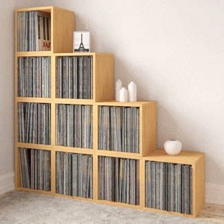 a set of wooden shelves filled with vinyl records