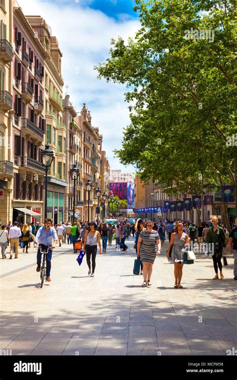 People walking down one of the busy shopping streets in Barcelona on a ...