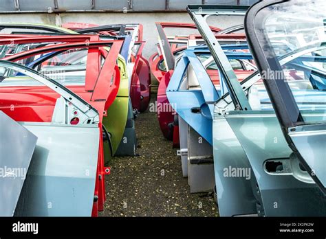 different colored car doors at a car junkyard Stock Photo - Alamy