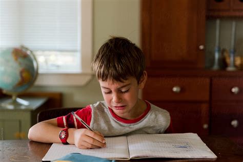 "Little Boy Crying While Doing His Homework" by Stocksy Contributor "Lea Jones" - Stocksy