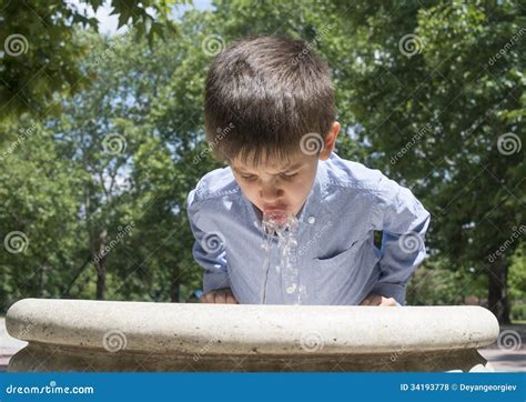 Child Drinking Water from a Fountain Stock Photo - Image of caucasian, park: 34193778