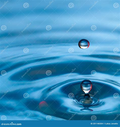 Blue Water Drop Splash with Red Tones Stock Photo - Image of ripple ...