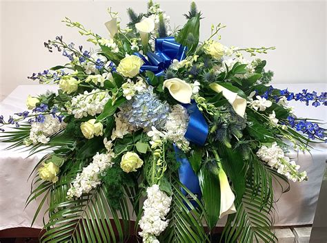 Blue and White Casket Spray by Dolly's Florist