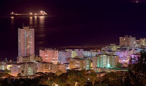 Premium Photo | Lights buildings and city at night with a harbour for ...