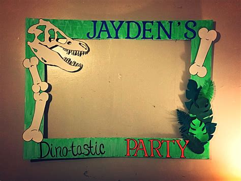 a green and white photo frame that says jayden's dinosaur party