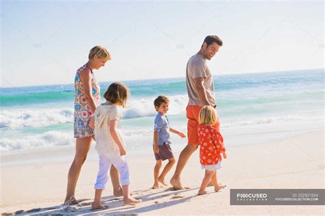 Family walking on the beach — vacations, life - Stock Photo | #222921544