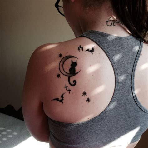 a woman with a cat and stars tattoo on her back