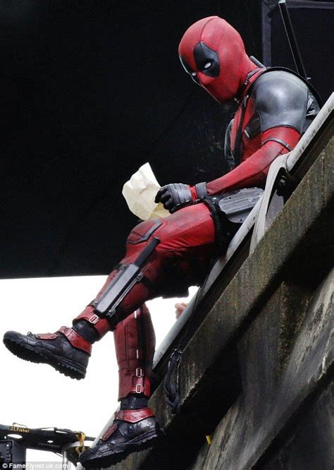 Ryan Reynolds holds letter while sitting on a bridge for Deadpool ...