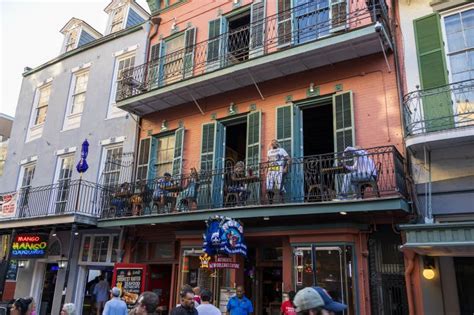 People Walking Along Bourbon Street with Restaurants and Bars in the ...