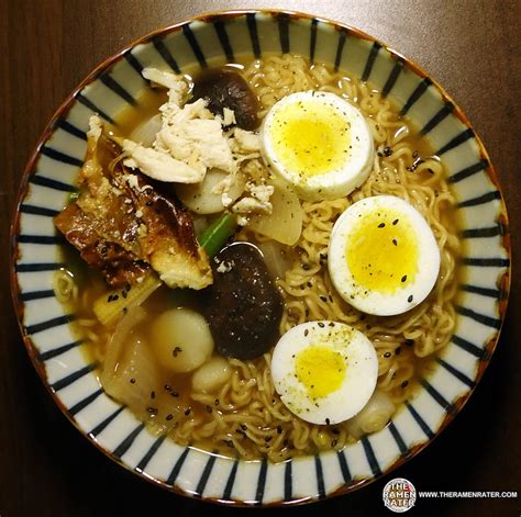 a bowl filled with noodles and eggs on top of a table