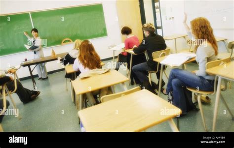 Teacher asking questions in class Stock Photo - Alamy