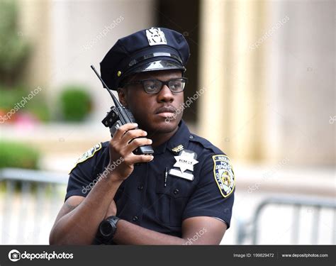 Police officer performing his duties on the streets of Manhattan. New York City Police ...