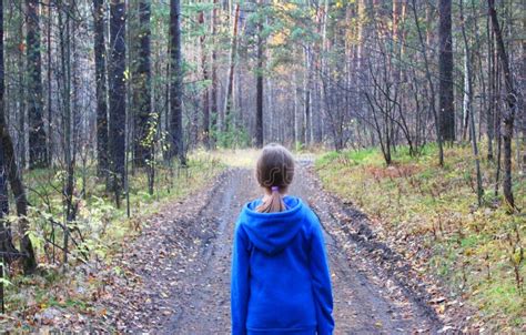 A Girl Walks Alone while Walking through the Forest on an Autumn Day. Loneliness and Melancholy ...