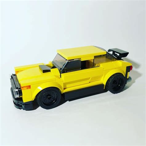 a yellow lego car is shown on a white background