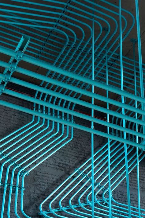 Turquoise electrical conduit is a design feature running through this office space | Office ...