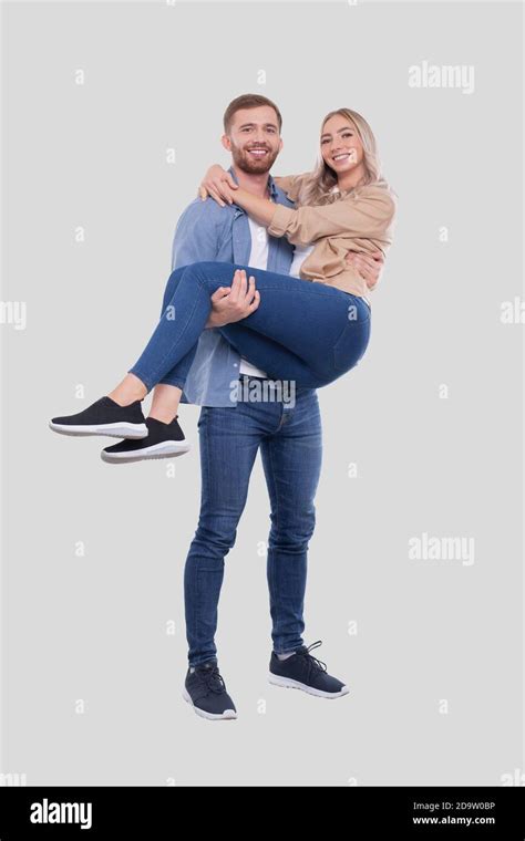 Man Holding Girl in his Arms. Couple Standing Isolated Stock Photo - Alamy