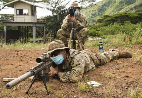 A sniper team works together to sight in targets at a qual… | Flickr